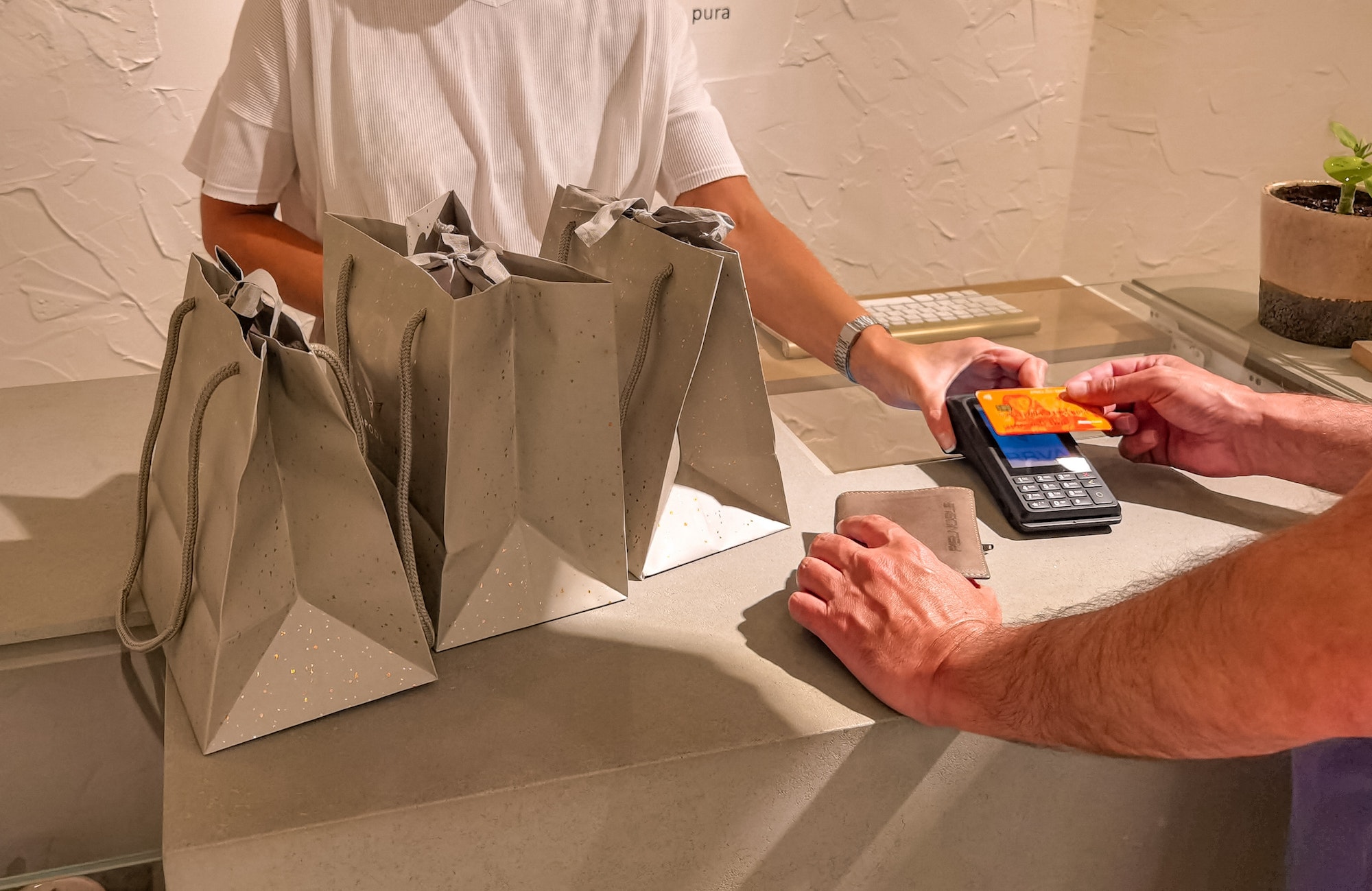 Man paying gifts in a retail shop with a credit card