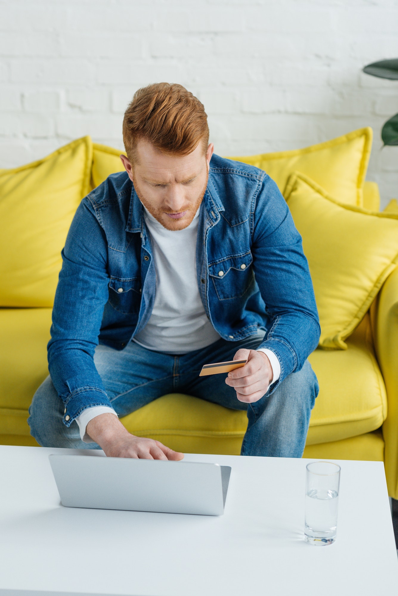 Man with credit card and laptop making online payment